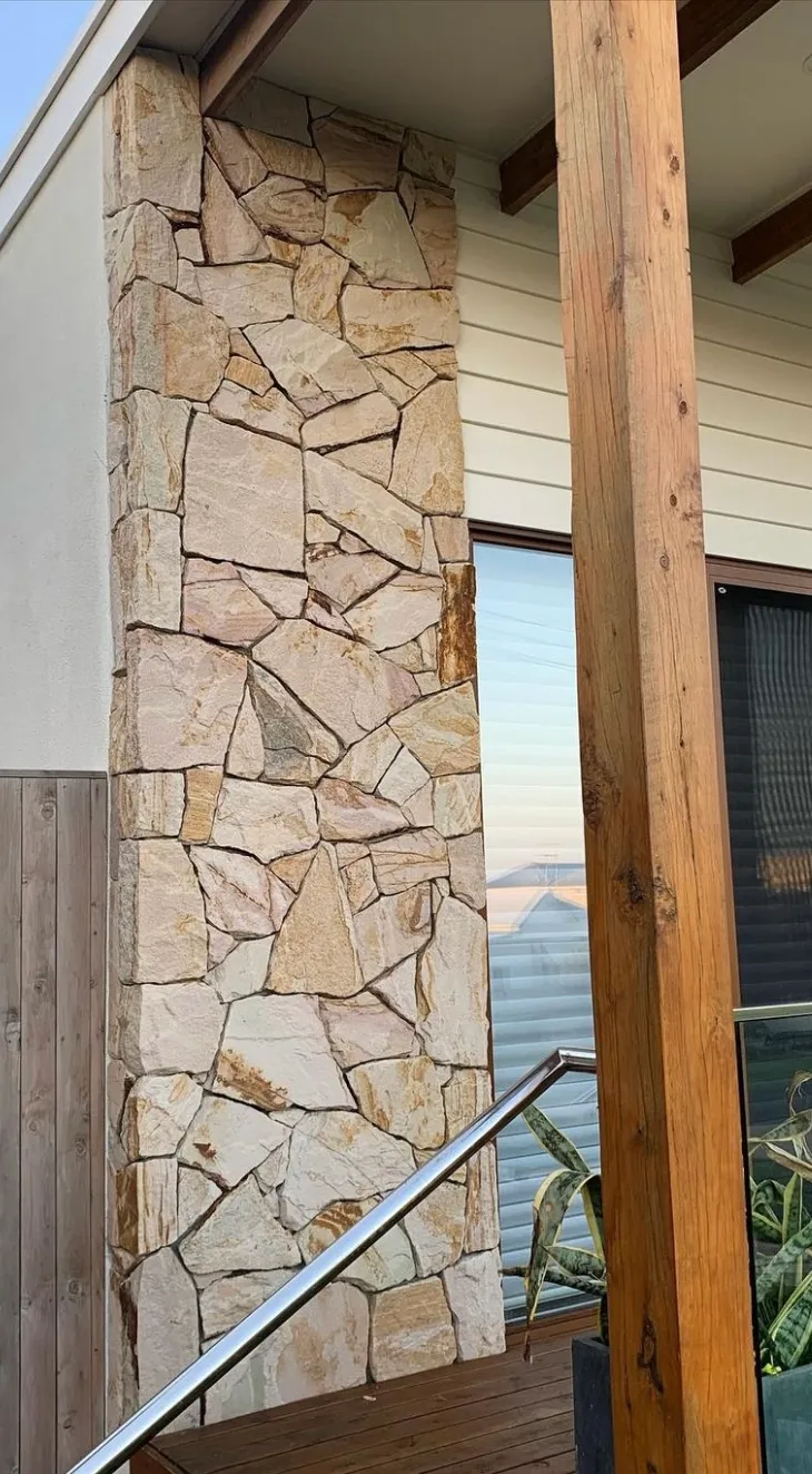 Pale sandstone cladding on a verandah post and wall