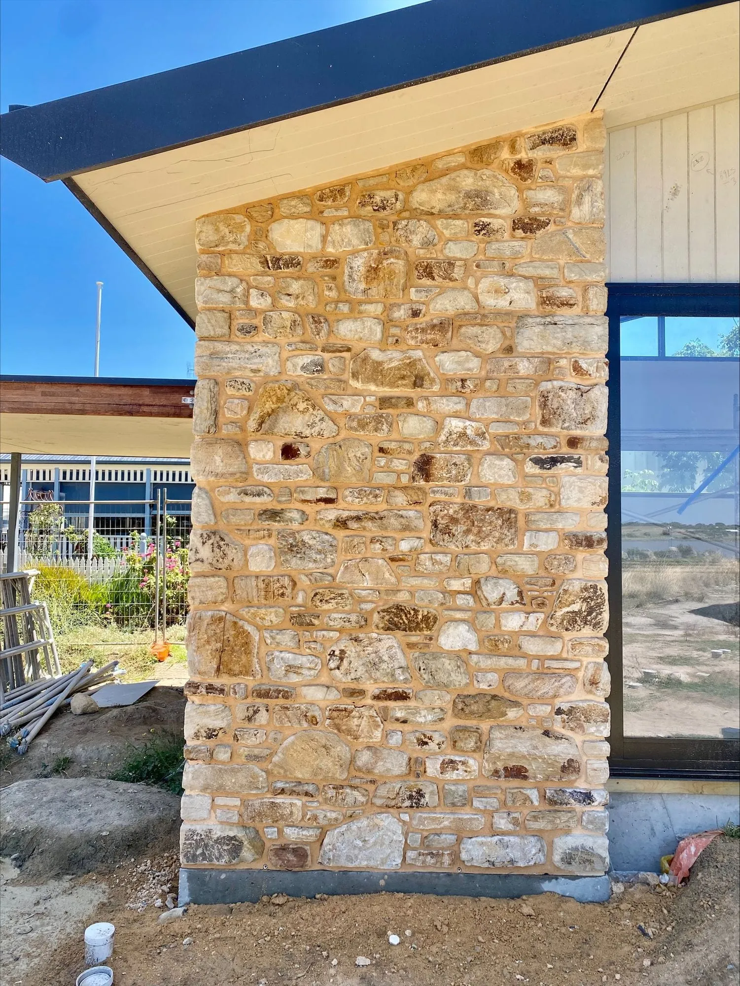 A stone pier beside a large window